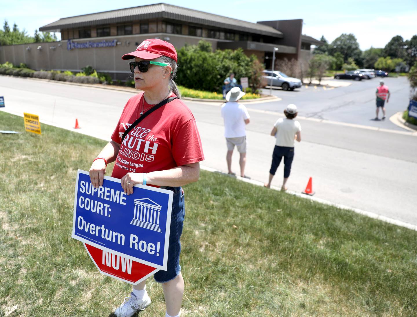 Corrine Marsala of Bolingbrook stands across the street from the Planned Parenthood health center in Aurora on Friday, June 24, 2022 a few hours after news broke regarding The Supreme Court’s decision to overturn Roe vs. Wade.