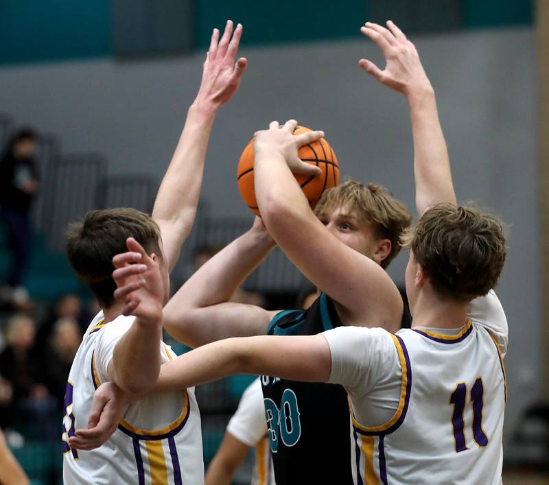 Woodstock North's Lincoln Buening tries to get a shot off between the defense of Hononegah’s Jace Brady (left)  and Hononegah's Oba Fasalojo (right) during the 2025 Hoops for Healing tournament basketball game on Wednesday, Nov. 26, 2025, at Woodstock North High School.