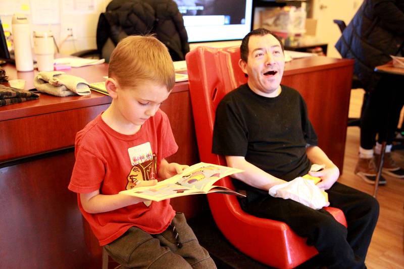 Grace McWayne Elementary School first grader Elijah Hammar reads to Marklund Hyde Center resident Jesus as the children also created Valentines with the residents on Wednesday, Feb. 7, 2024.