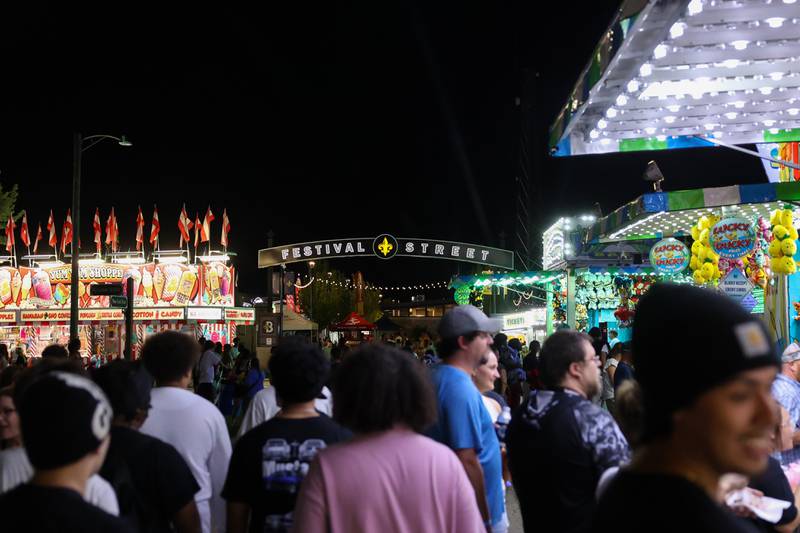 Festivalgoers enjoy the carnival along Festival Street during the 50th Bourbonnais Friendship Festival on Friday, June 27, 2025.
