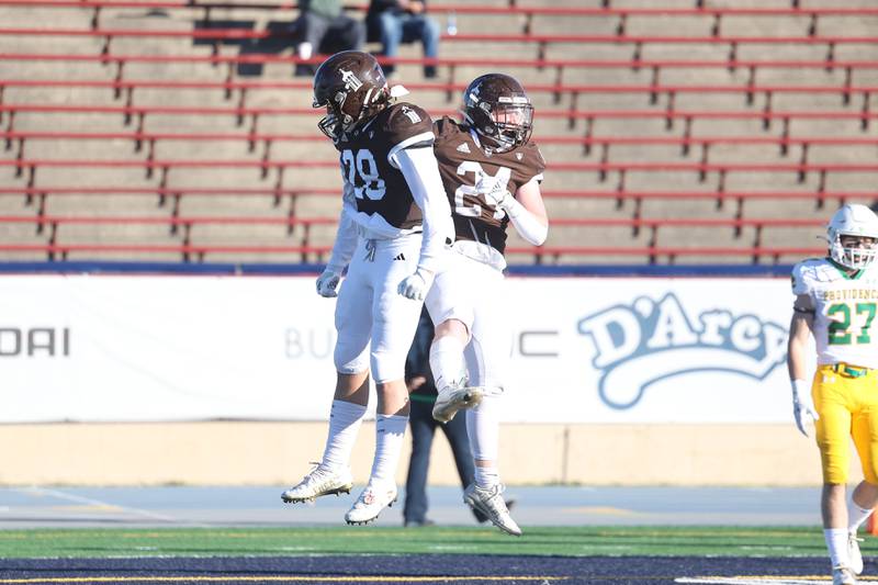 Joliet Catholic’s Nate Magrini, left, celebrates Larry Stringham’s touchdown against Providence in the Class 5A semifinal on Saturday, Nov. 18, 2023, in Joliet.