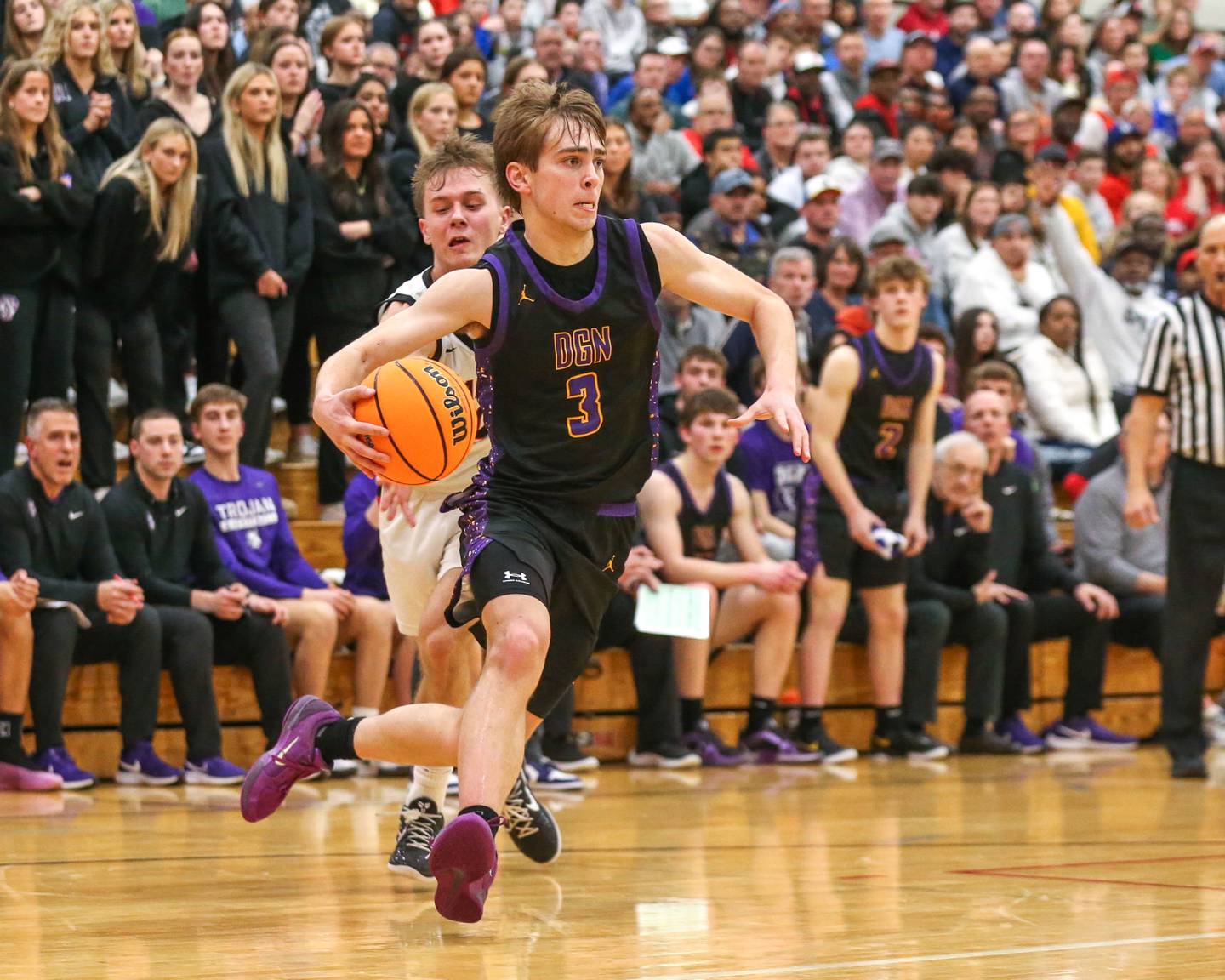 Downers Grove North's Nolan Hurter (3) makes a move to the basket during their Class 4A Bolingbrook Sectional semifinal basketball game between Downers Grove North at Bolingbook. March 4, 2025 in Lisle.