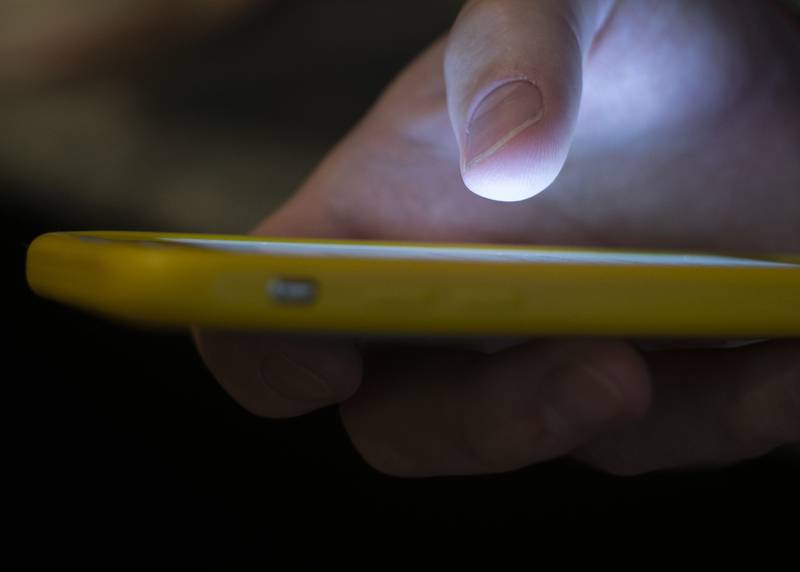 FILE - A man uses a cell phone in New Orleans on Aug. 11, 2019.  A number of Americans are dealing with cellular outages on AT&T, Cricket Wireless, Verizon, T-Mobile and other service providers, according to data from Downdetector, Thursday, Feb. 22, 2024.  (AP Photo/Jenny Kane, File)