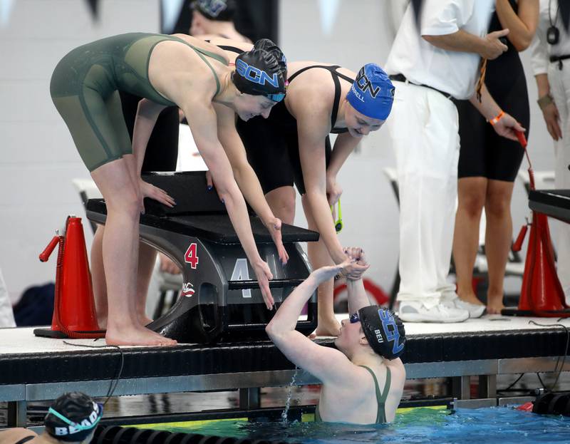 St. Charles North’s Isabelle Beu celebrates with her team following the 400-yard freestyle relay championship heat during the IHSA Girls State Championships on Saturday, Nov. 16, 2024 at FMC Natatorium in Westmont.