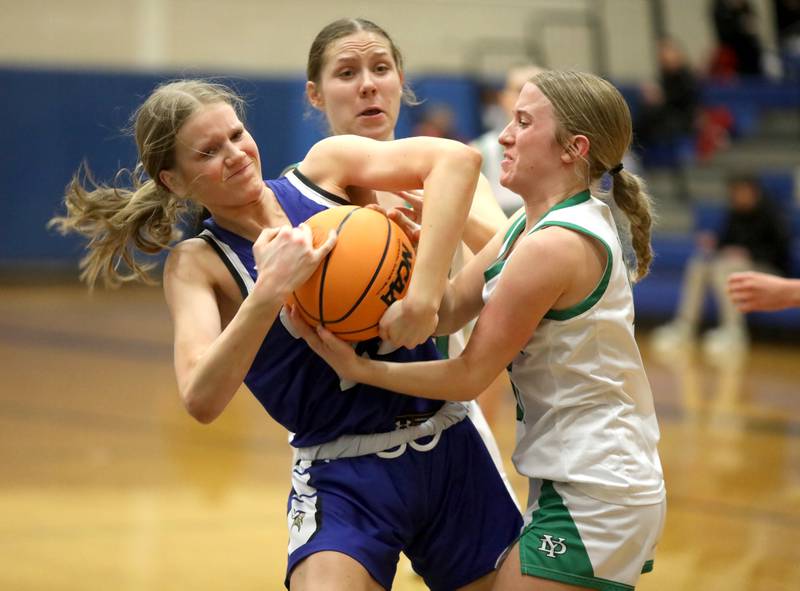 Geneva's Emma Peterson (left) and York’s Briley O'Brien battle for the ball during a 4A Geneva Regional semifinal game on Tuesday, Feb. 18, 2025 in Geneva.
