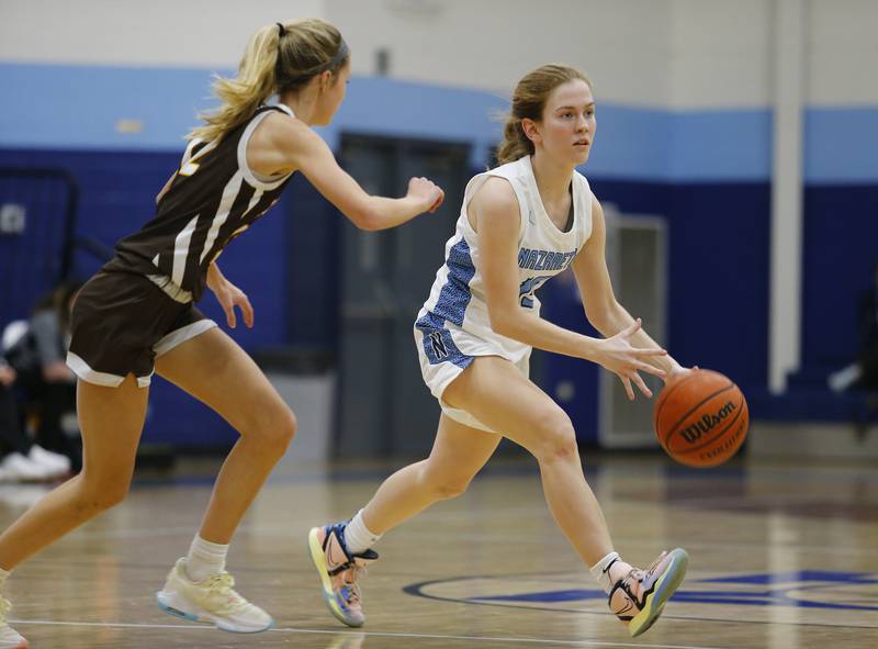 Nazareth's Mary Bridget Wilson (15) brings the ball up court during the girls varsity basketball game between Carmel High School and Nazareth Academy on Wednesday, Dec. 7, 2022 in LaGrange, IL.