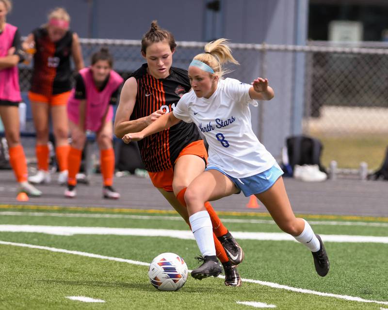 St. Charles North Keira Kelly (8) tries to keep the ball away from St. Charles East Kara Machala (during the second half of the sectional title game on Saturday May 27th held at West Chicago Community High School.