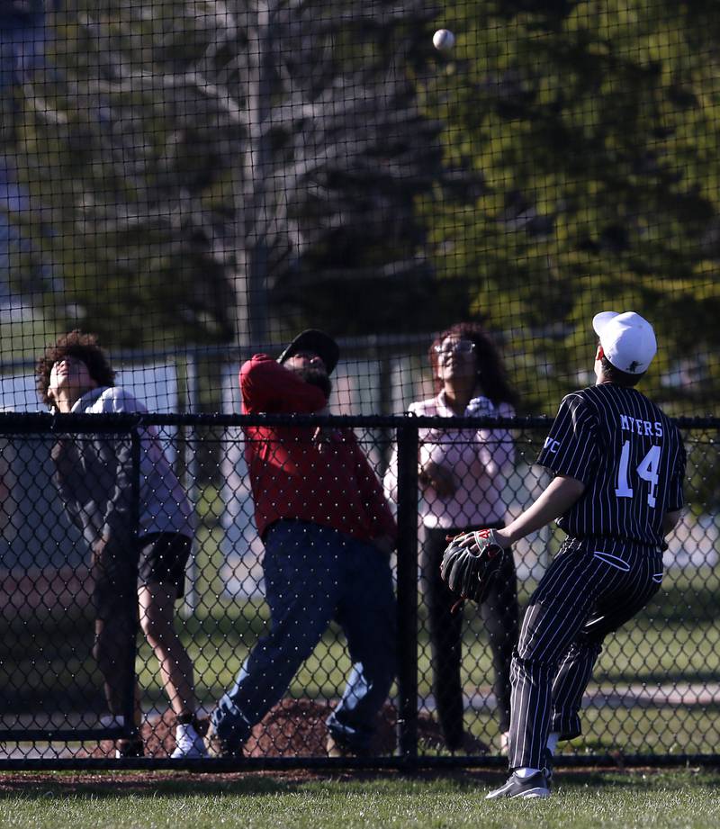 Fans scramble as Prairie Ridge's Ryan Myers watches the ball Goa foul during a Fox Valley Conference baseball game against Crystal Lake South on Monday, April 8, 2024, at Crystal Lake South High School.