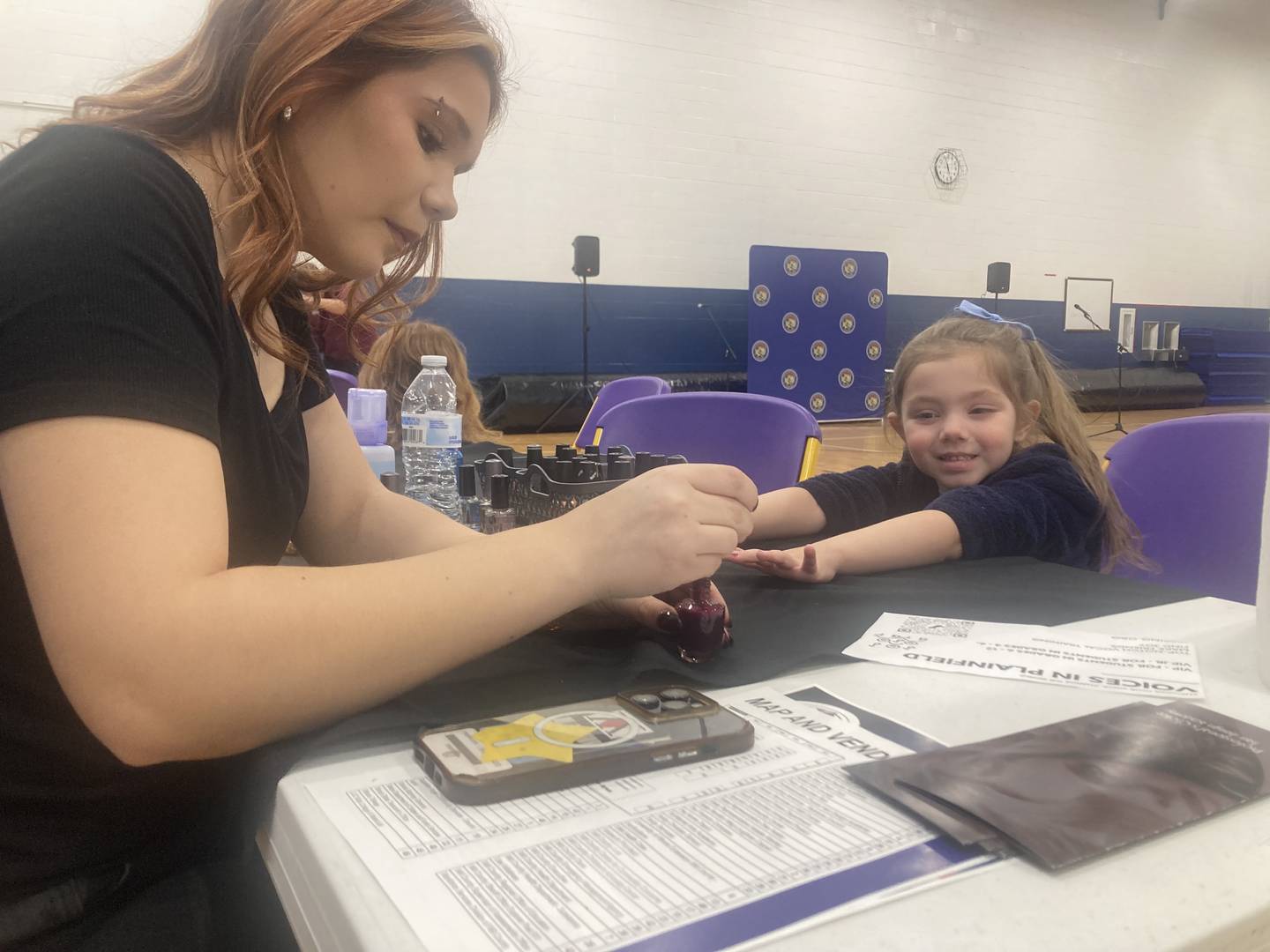 Raelynn Massey gets a manicure from Kit Brewer at the Professional's Choice Hair Design Academy booth at the Will County Kids Fair at Troy Middle School in Plainfield on Monday, Feb. 17, 2025.