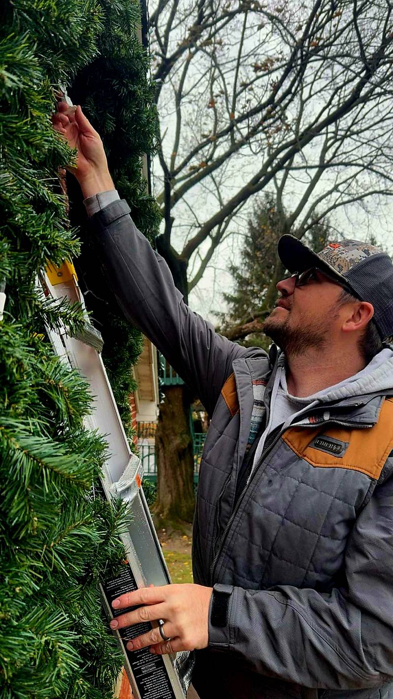 Jonathon Miller of Miller's Festive Lights, decorates as house with Christmas lights,