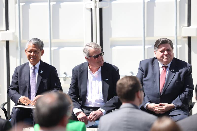 Gil Quiniones, CEO of ComEd, left, John Mueller, chairman, and owner of G&W Electric, and Gov. J.B. Pritzker attend an event outside the G&W Electric building in Bolingbrook.