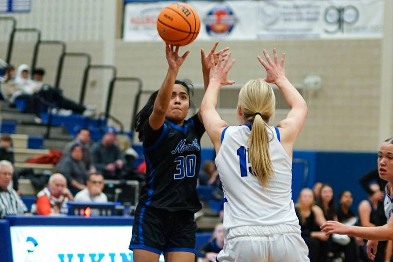 St. Charles North's Lelanie Posada (30) shoots a 3-pointer against Geneva’s Emma Peterson (15) during a game at Geneva High School on Thursday, Dec. 4, 2025.