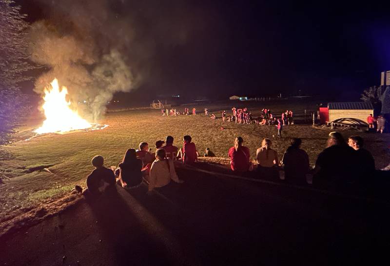 Oregon High School students gather around the homecoming bonfire following a parade on Wednesday, Sept. 18, 2024. Homecoming festivities continue this week with the Hawks hosting Winnebago on the football field Friday night.