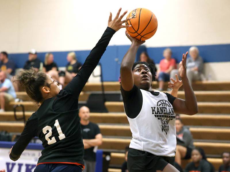 Kaneland’s Amani Meeks goes to the basket against DeKalb’s Alicia Johnson Thursday, June 12, 2025, in the Geneva High School Varsity Summer League.