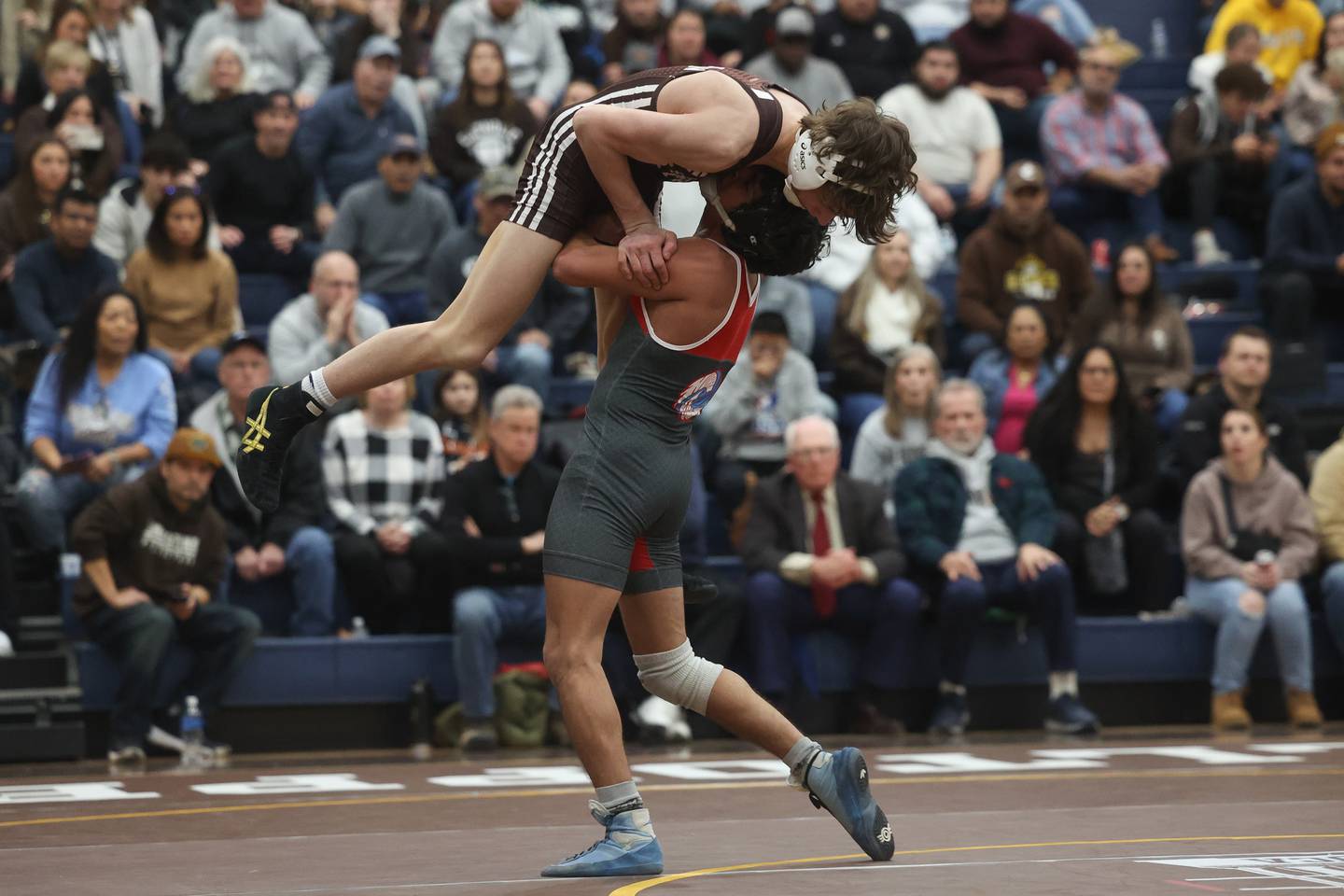 Marian Central’s Anthony Alanis lifts Joliet Catholic’s Matt Laird in the tri-meet at Joliet Catholic on Thursday, Jan. 18th, 2024 in Joliet.