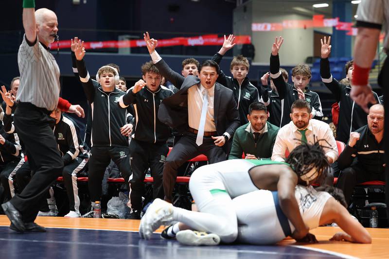 Providence Catholic coaches and players celebrate as Jasper Harper earns points against IC Catholic's Jacob Alvarez during IC Catholic's victory in the IHSA Class 2A Dual Team State championship on Saturday, Feb. 28, 2026.