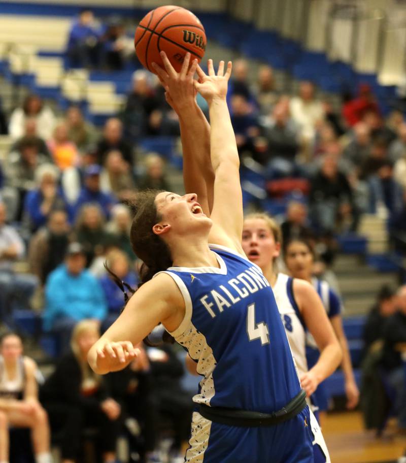 Wheaton North’s Elsa Carlson reaches for a rebound during a game at Geneva on Friday, Dec. 22, 2023.