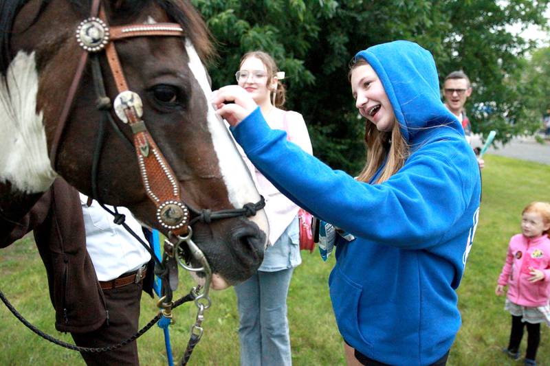 Emily Hern, 13, of St. Charles pets the nose of Kane County Rangers horse Shiloh as Evelyn Hern, 16, (left) looks on duirng the Kane County Sheriff’s National Night Out in St. Charles on Tuesday, Aug. 6, 2024.