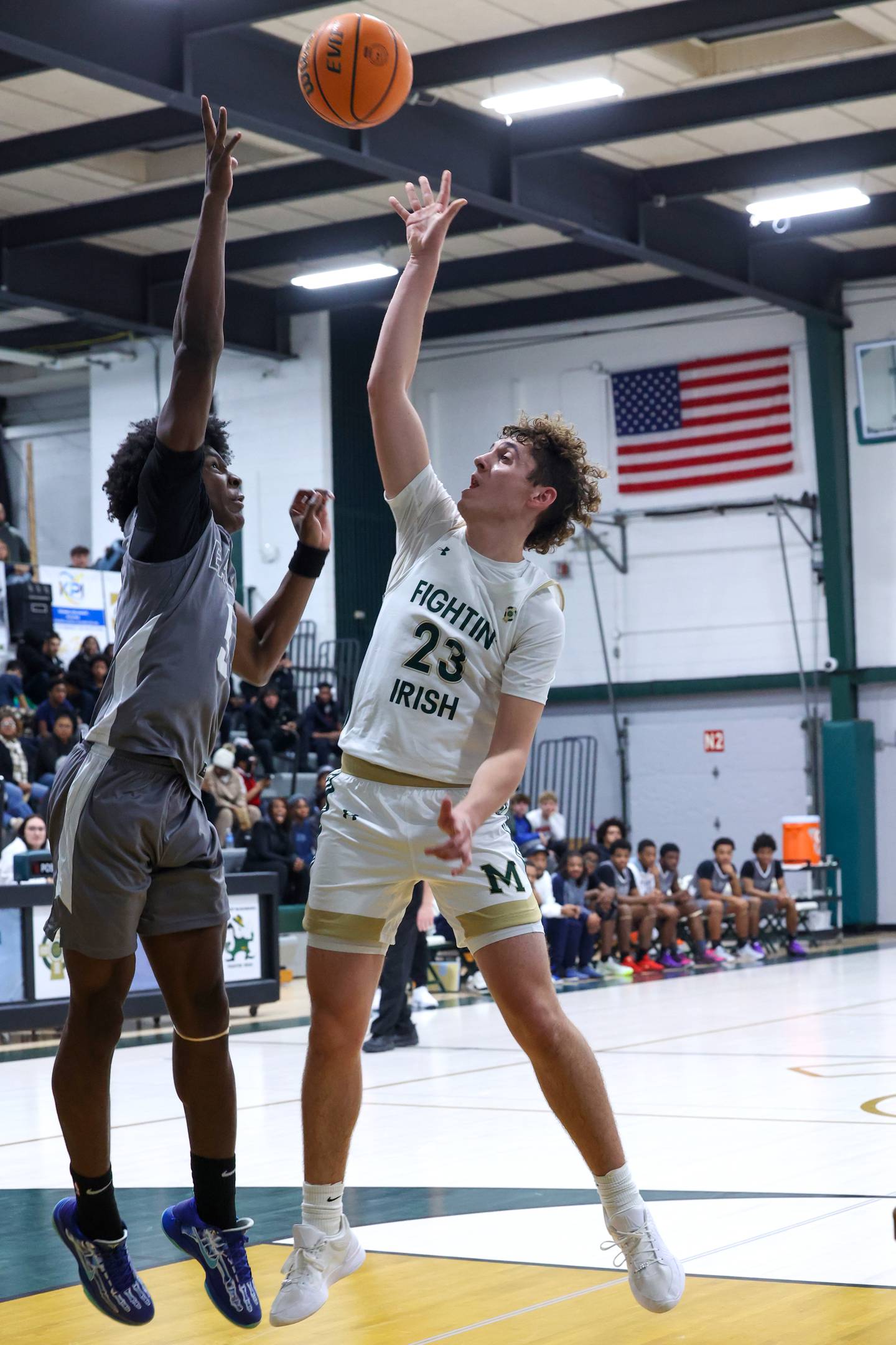 Bishop McNamara's Karter Krutsinger shoots over a Hope Academy defender during the Fightin' Irish's 70-51 loss on Tuesday, Dec. 9, 2025