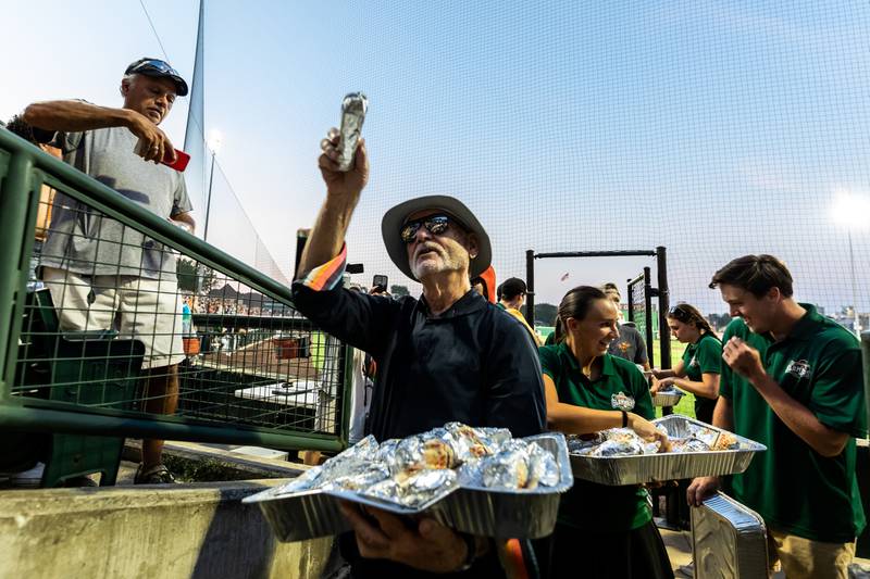 Slammers co-owner Bill Murray joins Slammers staff members to help distribute hot dogs to fans following the Wiener Drop World Record Attempt, sponsored by Pabst Light, at Slammers Statidum on July 22, 2025.