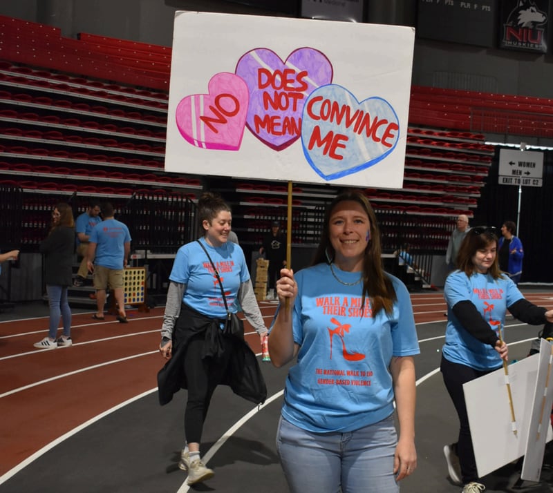 Participants pose for a photo at Safe Passage's annual Walk A Mile in Their Shoes event on April 18, 2026, at the Northern Illinois University Convocation Center in DeKalb. The event, held to raise awareness of sexual violence and supoprt survivors, was hosted by the nonprofit as part of Sexual Assault Awareness Month.