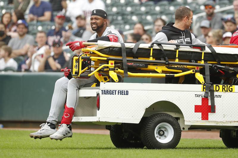 Chicago White Sox outfielder Eloy Jimenez leaves the field on a cart after running out a grounder against the Minnesota Twins on Saturday, April 23, 2022, in Minneapolis.