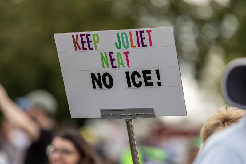 A protestor holds a sign denouncing ICE during the No Kings Protest at Mall Loop Drive in Joliet on Oct. 18, 2025.