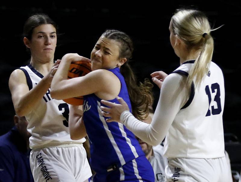 Cary-Grove's Kennedy Manning tires to get a jumps ball as she guards Burlington Central's Kelsey Covey in front of Cary-Grove's Malaina Kurth during a Fox Valley Conference basketball game  on Tuesday, Jan. 14, 2025, at Now Arena in Hoffman Estates.