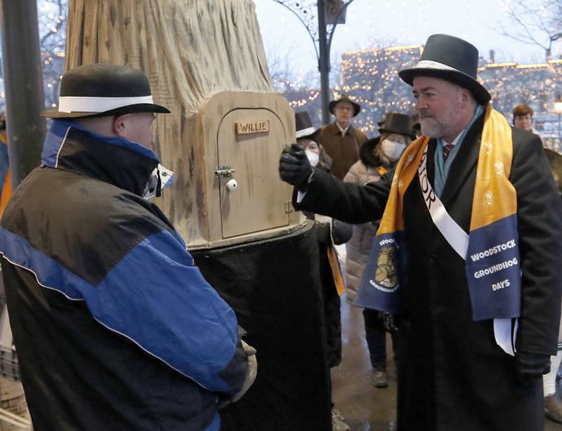 Woodstock Mayor Mike Turner wakes up Woodstock Willie Wednesday, Feb, 2, 2022, during the annual Groundhog Day Prognostication on the Woodstock Square.