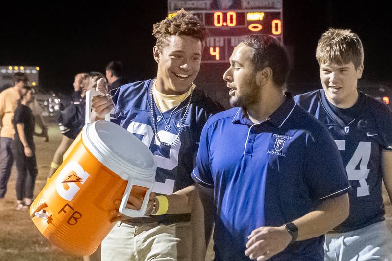 Lucas May of Fieldcrest walks with coach David Vasquez after win on Friday, September 20, 2024 at Fieldcrest high school in Minonk.