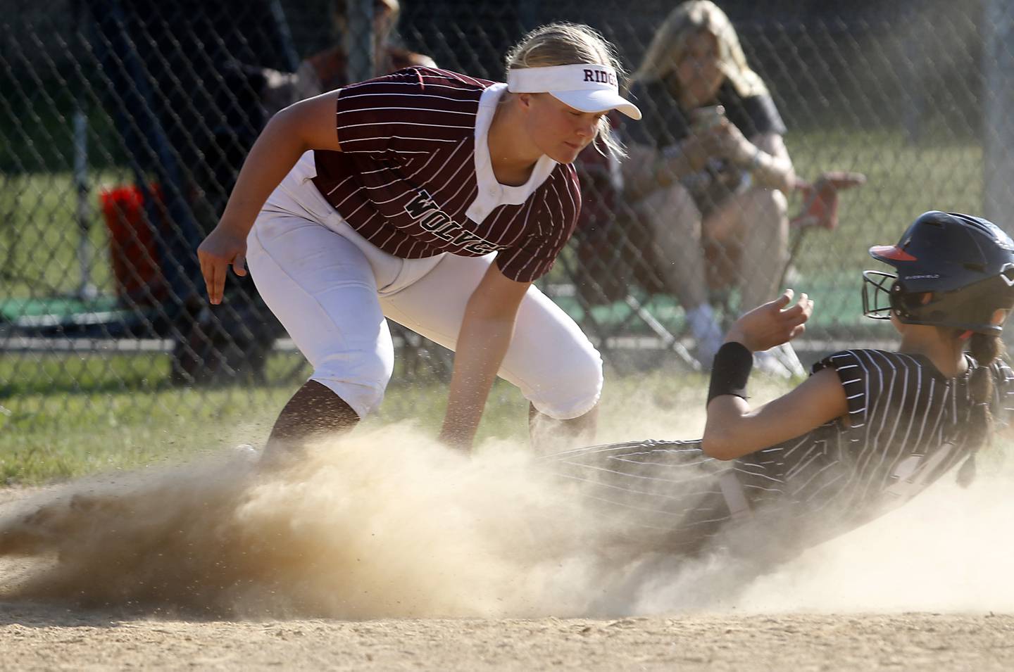 Prairie Ridge's Bella Moore tags out Crystal Lake Central's Lily Perocho as she slides into third base during a Fox Valley Conference  softball game on Wednesday, May 14, 2025, at Crystal Lake Central High School.