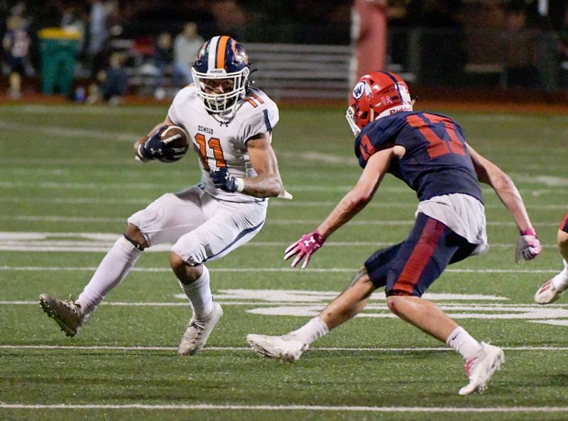 Oswego's Mark Melton (11) works to get around West Aurora's Austin Pierce (17) as he runs the ball inthe third quarter of a game in Aurora on Friday, October 8, 2021.