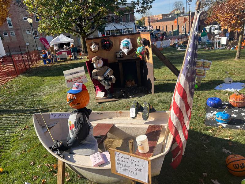 A display of a pumpkin fisherman on Oct. 25, 2024, sits in front of the 2024 Sycamore Pumpkin Festival's President's Award winner, which was created by the Palmer family.