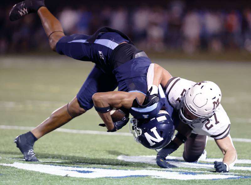 Mt. Carmel's Terry O'Connor (27) brings down Nazareth's Trenton Walker (1) during the varsity football game between Mt. Carmel high school and Nazareth Academy on Friday, Sept. 12, 2025 in La Grange Park, IL.