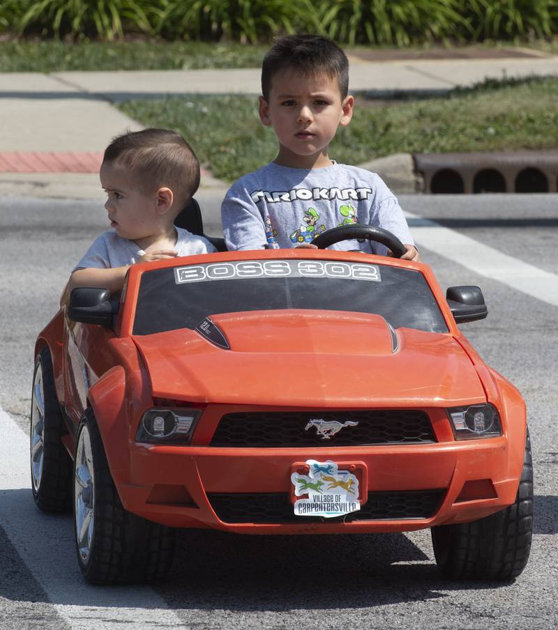 Joe Lewnard/jlewnard@dailyherald.com
Even Rivas, 1-1/2 of Algonquin and his brother, Shawn, 4-1/2, ride in style as they head to the Algonquin Founders Day parade Saturday.