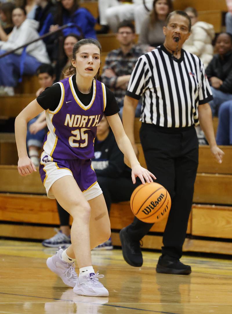 Downers Grove North's Caitlin Sandridge (25) dribbles the ball during the girls varsity basketball game between Downers Grove North and Lyons Township on Saturday, Jan. 11, 2025 in La Grange.
