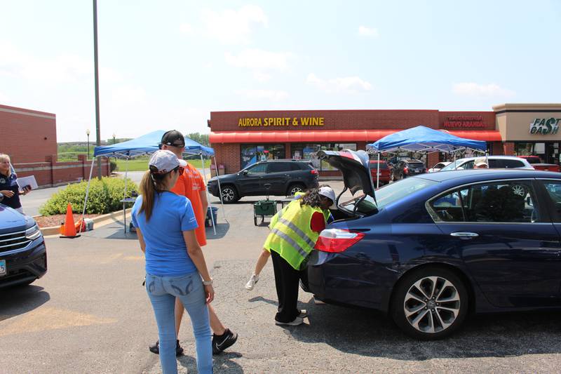 Volunteers check through the items being dropped off by a residents at State Rep. Stephanie Kifowit’s, D-Oswego, 12th annual Community Recycle & Shred Day in Aurora on July 13, 2024.