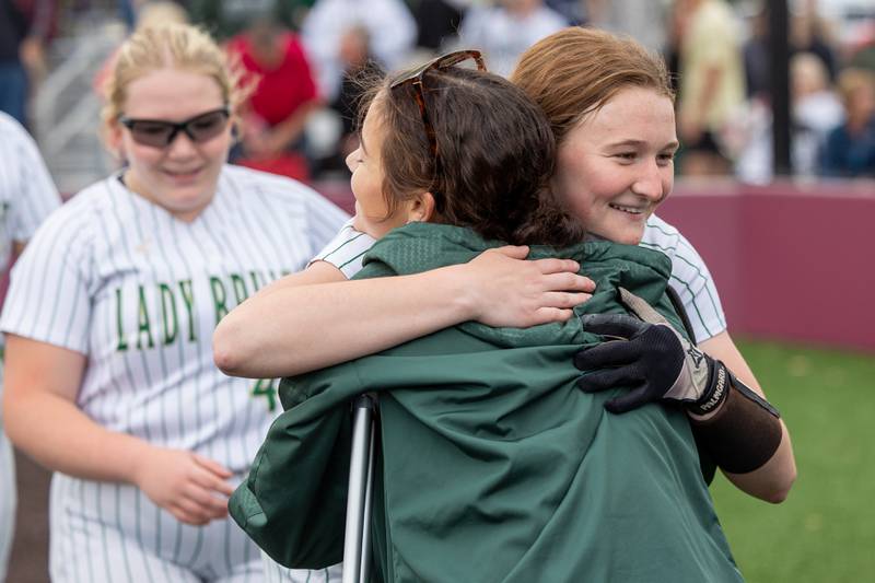 St. Bede's Lily McClain hugs injured teammate Bailey Engles after sectional championship win on Tuesday, May 27, 2025 at Illinois Valley Central High School in Chillicothe.