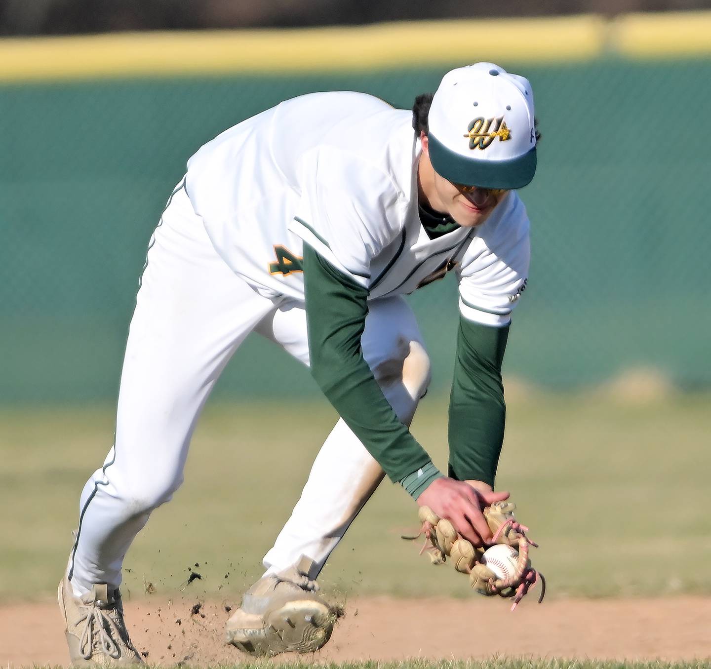 Waubonsie Valley shortstop Scott Gillen scoops up a ground ball by St. Charles East’s Antonio Perez in a baseball game in Aurora on Monday, Mar. 23, 2026.