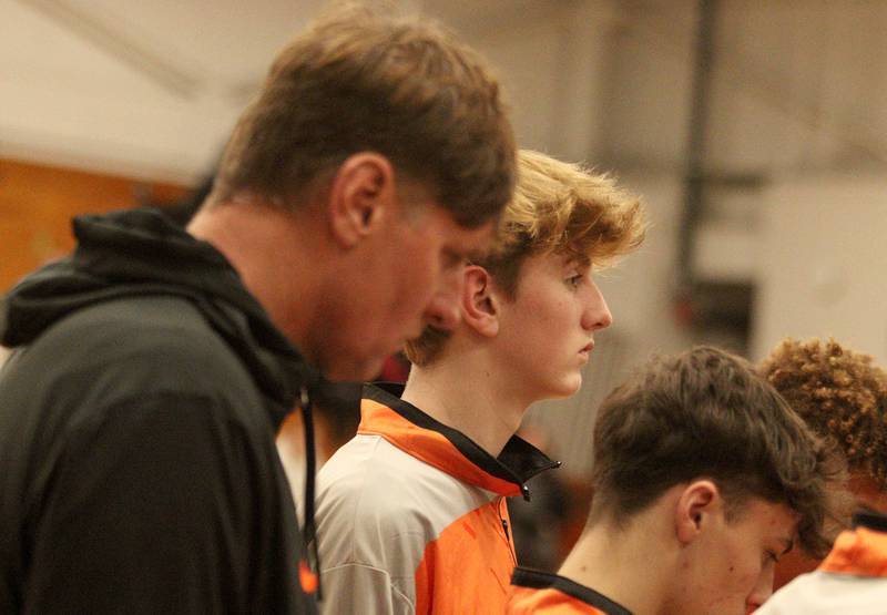 Crystal Lake Central’s Judson Parrish, center, and his dad Tim listen in during a time out against Huntley in tournament basketball action at Johnsburg High School Monday evening.