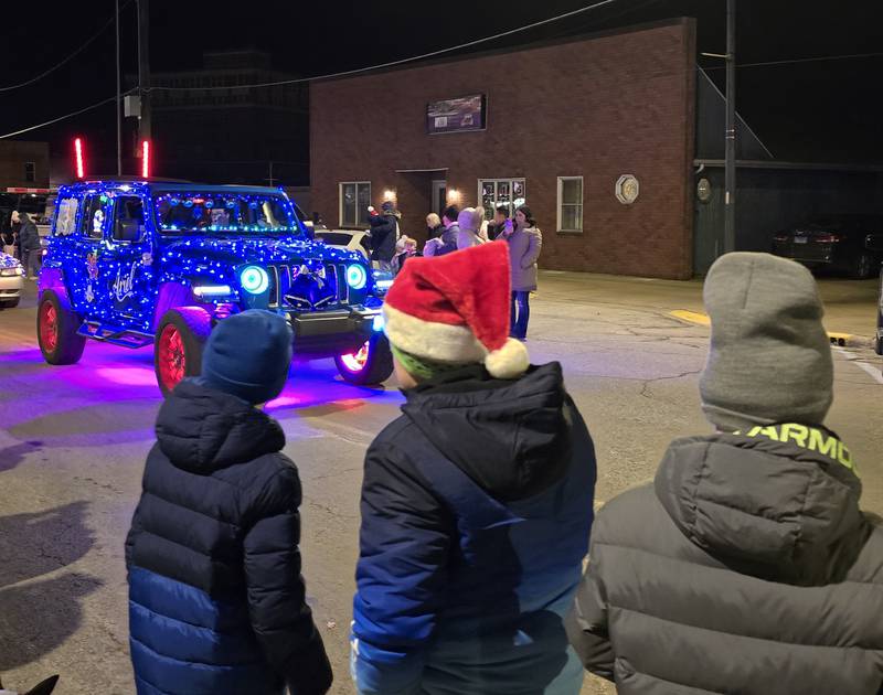 Children watch as a lighted jeep makes its way Saturday, Dec. 7, 2024, along the Holiday Magic Lighted Santa Parade in Marseilles.