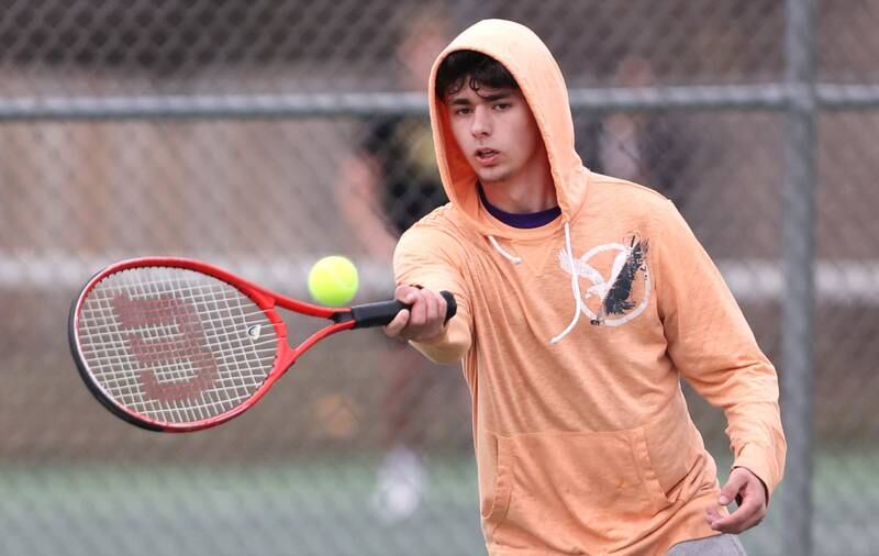 Dixon’s number two singles player Damien Beck hits a forehand during his match against Sycamore Thursday, March 30, 2023, at Sycamore High School.