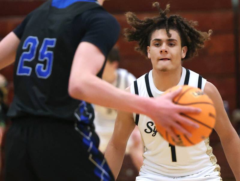 Sycamore's Josiah Mitchell plays defense against Woodstock's Liam Laidig Friday, Feb. 27, 2026, during their IHSA Class 3A boys basketball regional championship game at Boylan Catholic High School in Rockford.