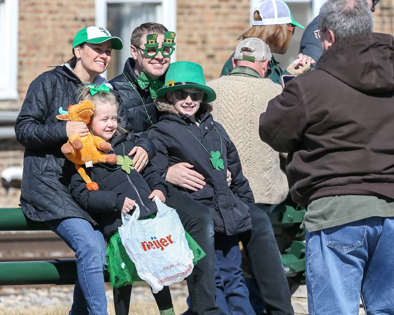 A family poses for pictures during the Lemont St. Pat's Day Parade on Saturday, March 8, 2025  in Lemont.