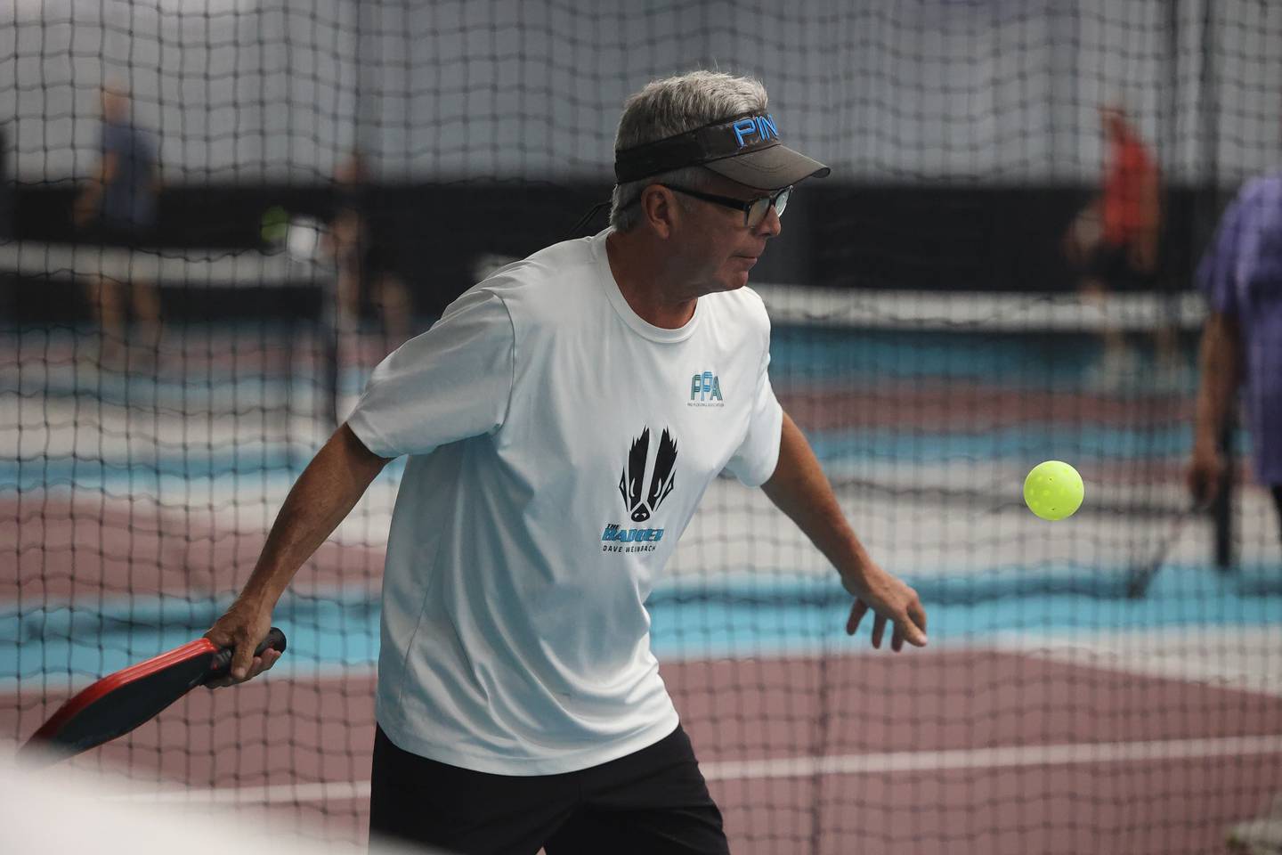 Mike O’Connell serves the ball in a pickleball league match at GameChangers on Tuesday, May 28, 2024 in Shorewood.