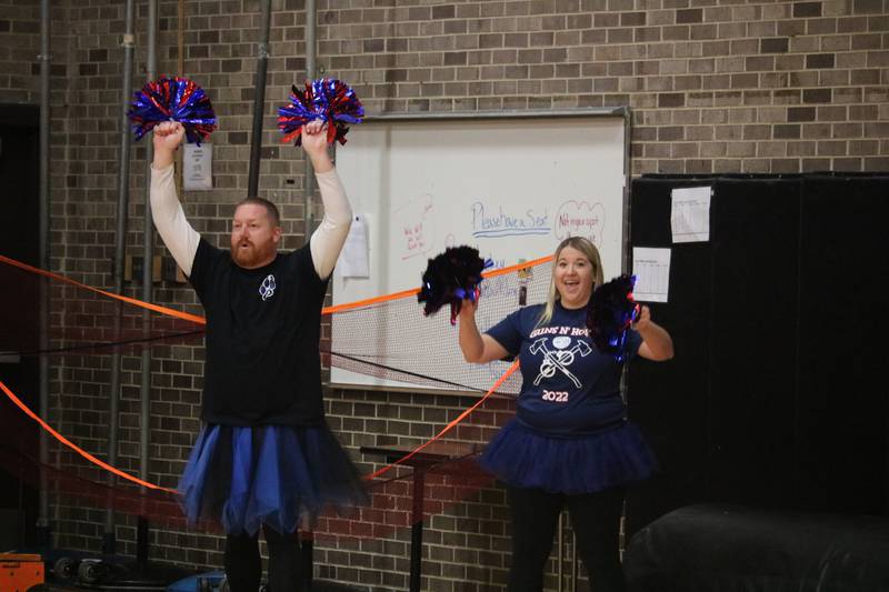 School Resource Officers Tony Densberger (left) and Allie Remner (right)  strike a pose in formation Monday, Dec. 5, 2022 during the Toys for Tots community basketball game.