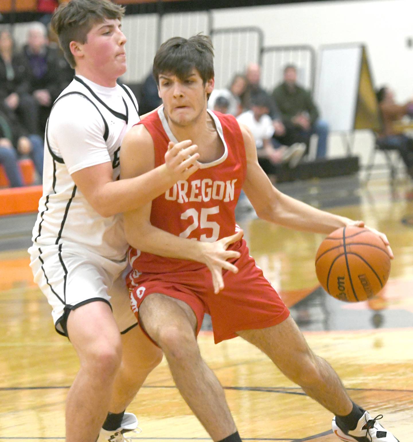 Oregon's Ryan Harkness (25) makes a move to the basket as Byron's Caden Considine defends during Friday, Jan. 20 Big Northern Conference game in Byron.