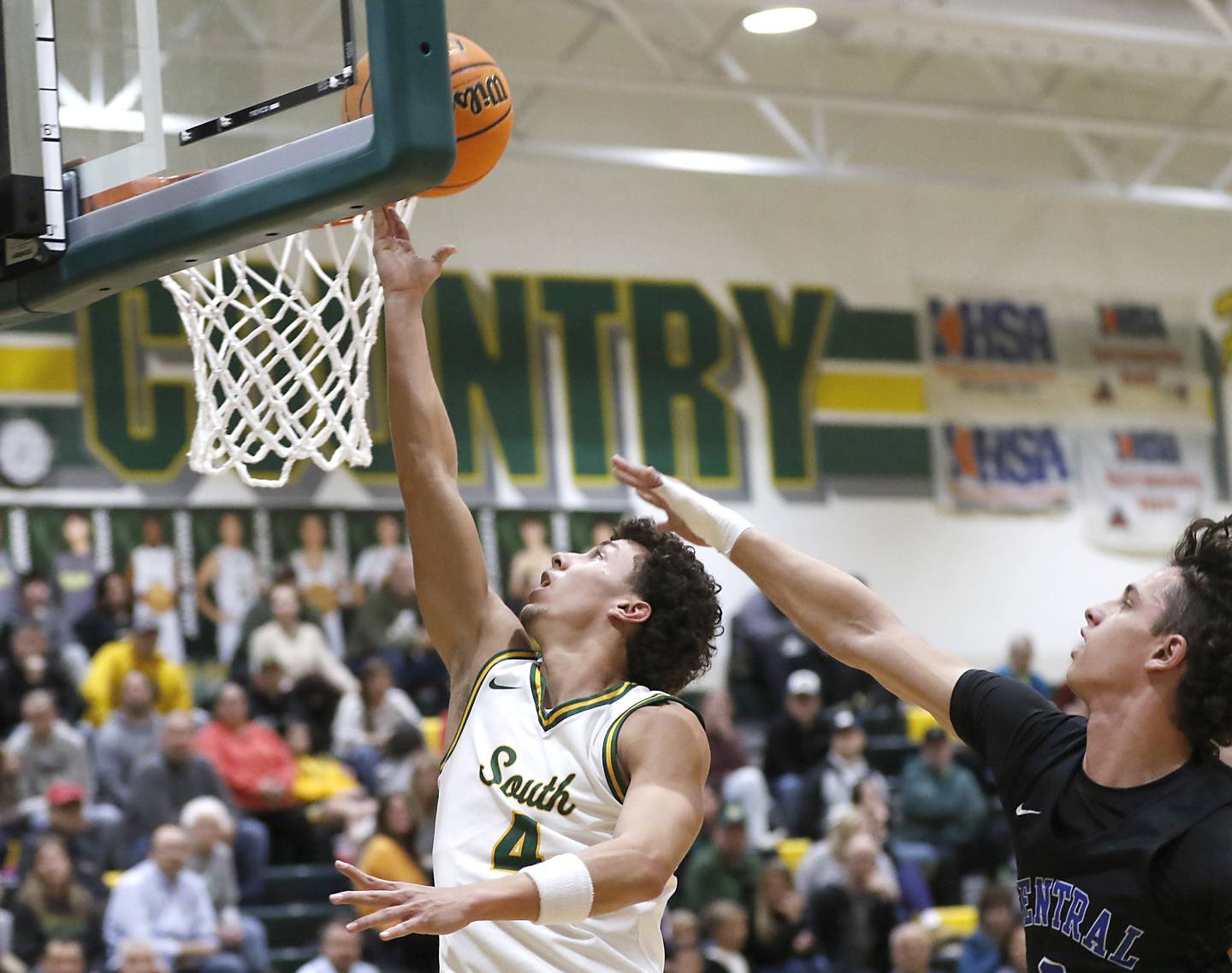 Crystal Lake South's Anthony Demirov drives to the basket against Burlington Central's LJ Kerr during a Fox Valley Conference basketball game on Tuesday, Jan. 28, 2025, at Crystal Lake South High School.