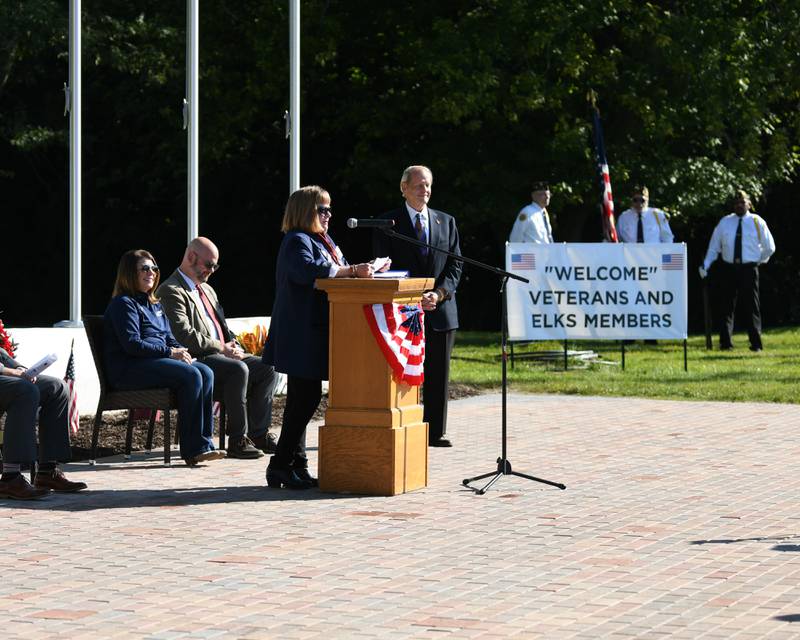 DeKalb Elks Lodge No. 765 Exalted Ruler Lynne Kunde welcomes the crowd during a dedication ceremony marking the completion of phase one of the DeKalb Elks Veteran’s Memorial Plaza in DeKalb Saturday, Oct. 1, 2022.