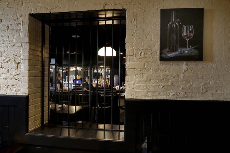 Bars separate a dining room and the bar area of the remodeled Public House of Woodstock on Tuesday, Aug. 29, 2023. The restaurant recently reopened after the newly remodeled Old Courthouse and Sheriff's House opened.
